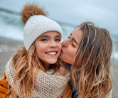 Parent kissing child